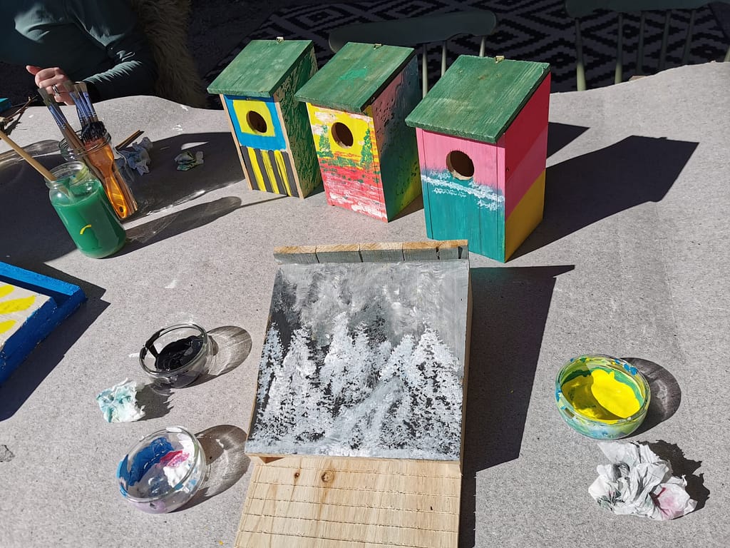 several painted birdhouses/bat boxes on a table at Näsets Marcusgård